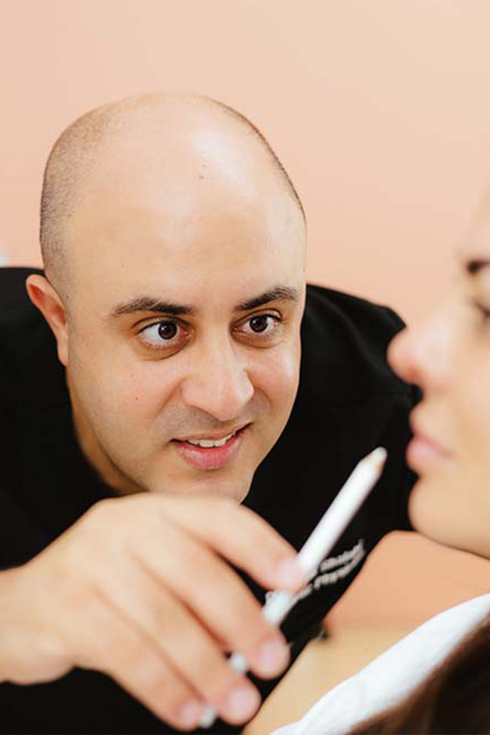 Dr Tarek looking at a patients face